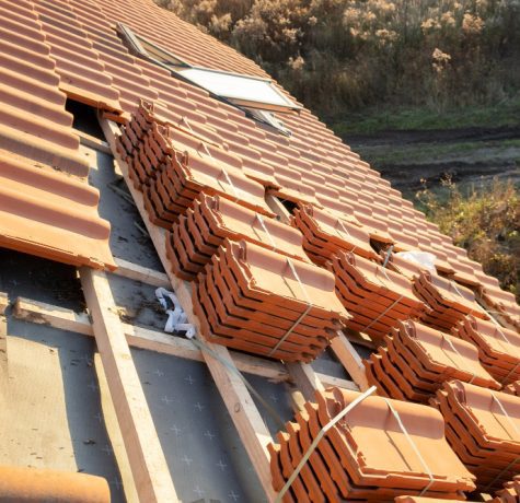 stacks yellow ceramic roofing tiles covering residential building roof construction