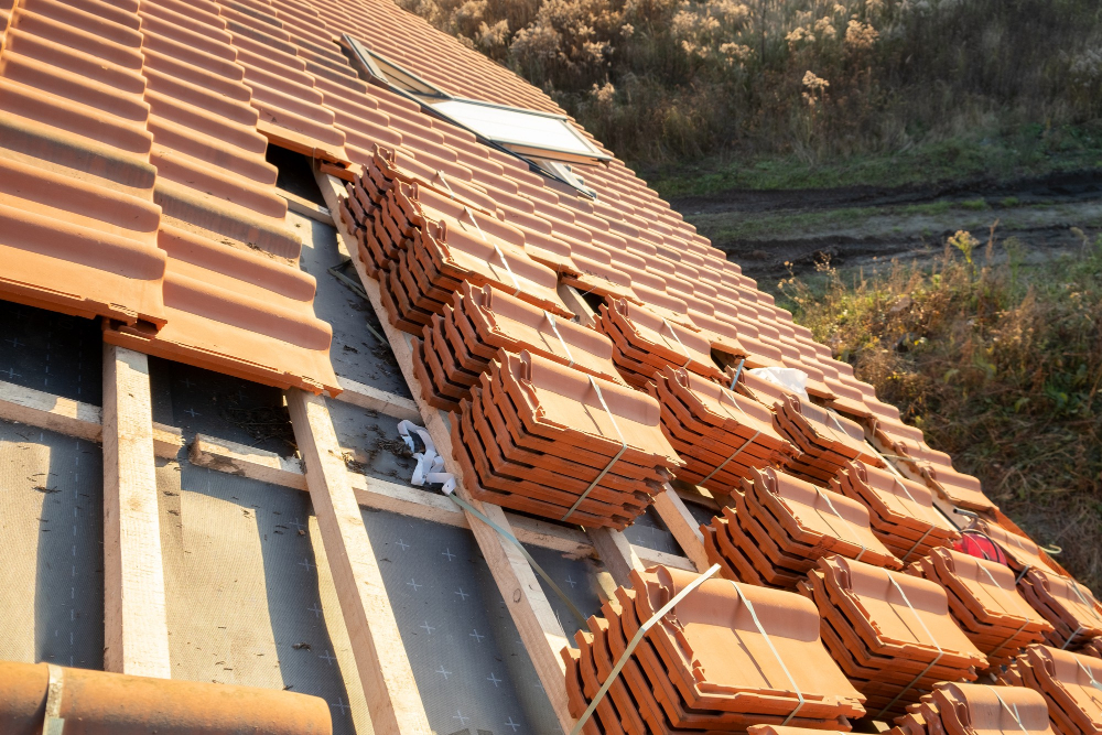 stacks yellow ceramic roofing tiles covering residential building roof construction